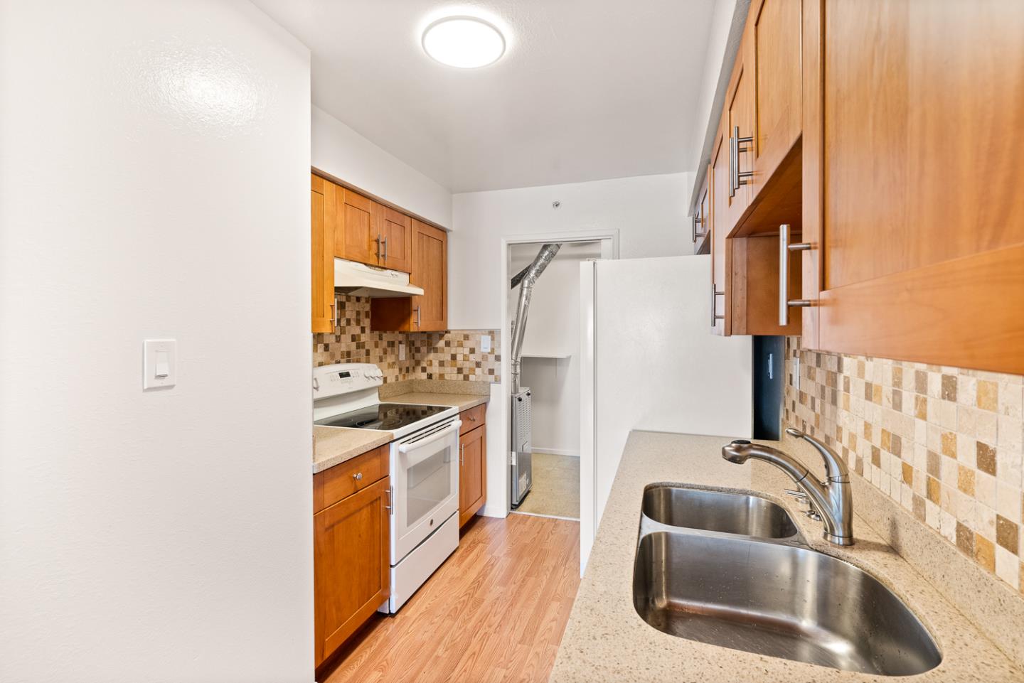 2419 Rowntree Way South San Francisco, CA 94080 - Photo 6 of 28 a kitchen with stainless steel appliances granite countertop a sink stove and refrigerator