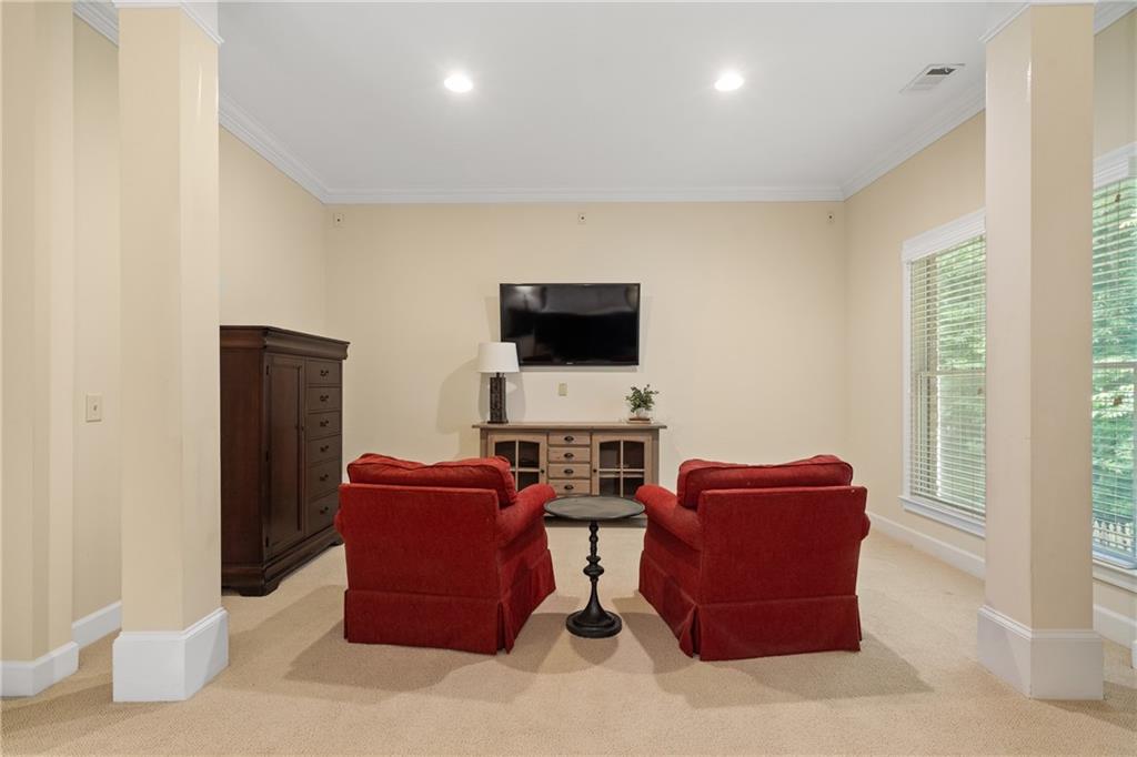 10567 Bent Tree View Duluth, GA 30097 - Photo 25 of 42 a living room with furniture a flat screen tv and a window