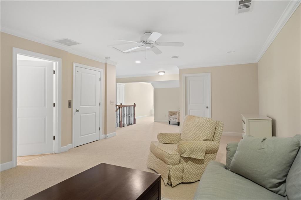 10567 Bent Tree View Duluth, GA 30097 - Photo 29 of 42 a living room with furniture and a chandelier