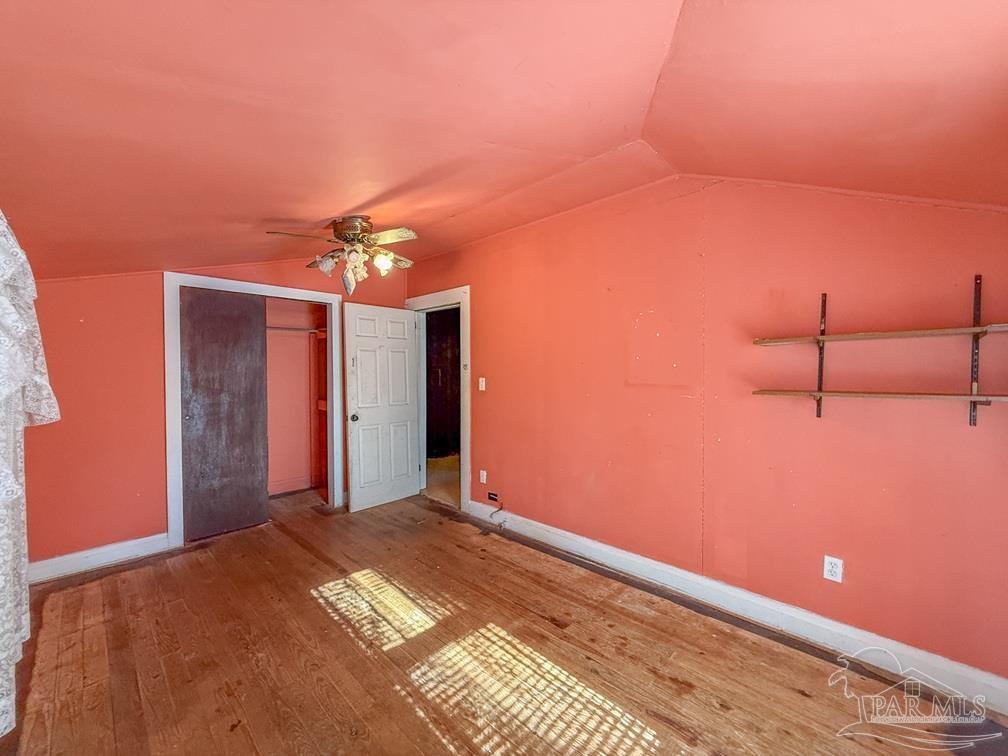 4550 Church Street Bagdad, FL 32583 - Photo 14 of 23 a bedroom with a bed and a chandelier