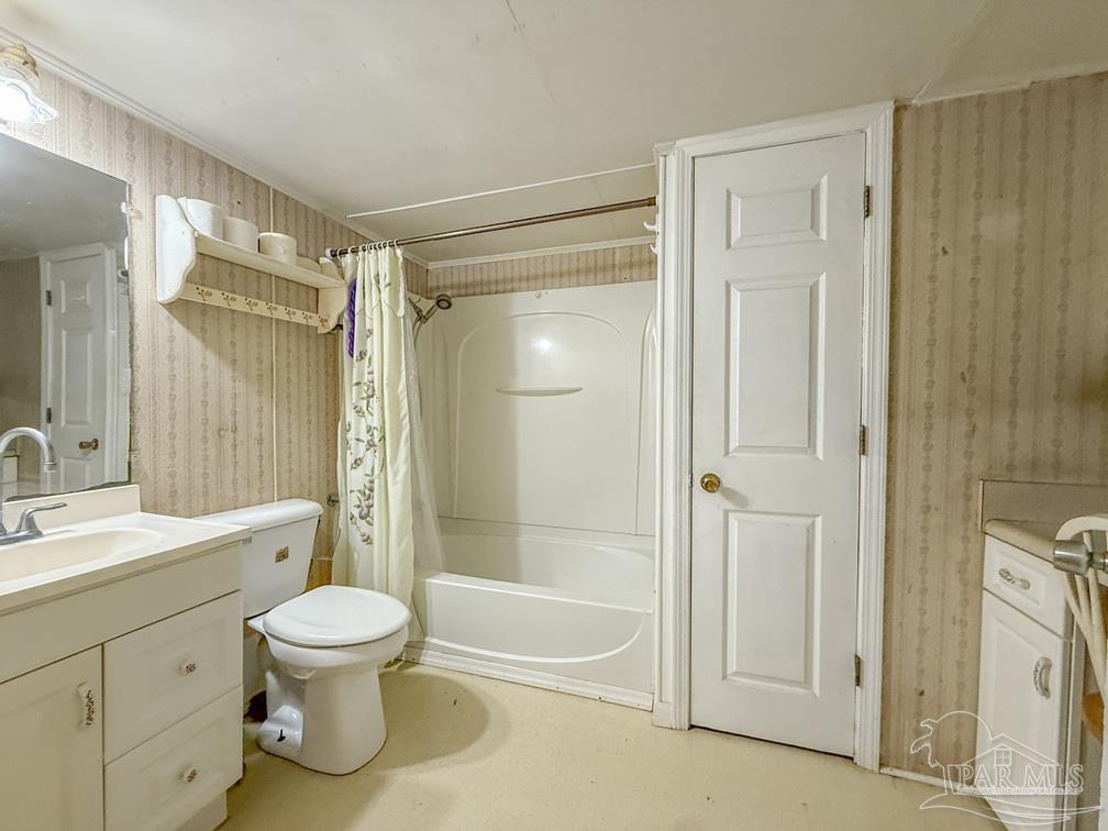 4550 Church Street Bagdad, FL 32583 - Photo 15 of 23 a bathroom with a shower a sink and a toilet