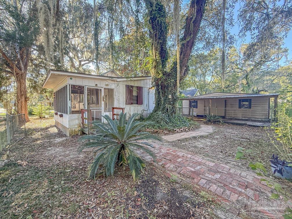 4550 Church Street Bagdad, FL 32583 - Photo 3 of 23 a view of a house with a yard and tree s