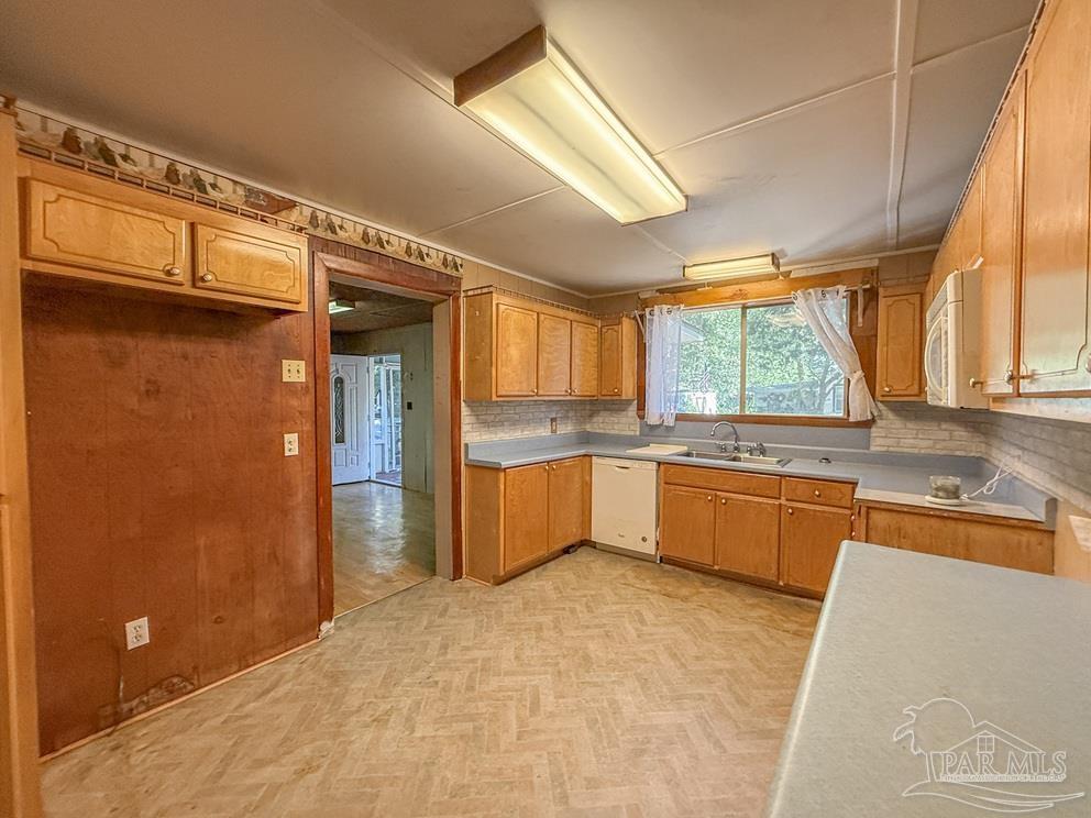 4550 Church Street Bagdad, FL 32583 - Photo 8 of 23 a large kitchen with stainless steel appliances granite countertop a refrigerator and a sink