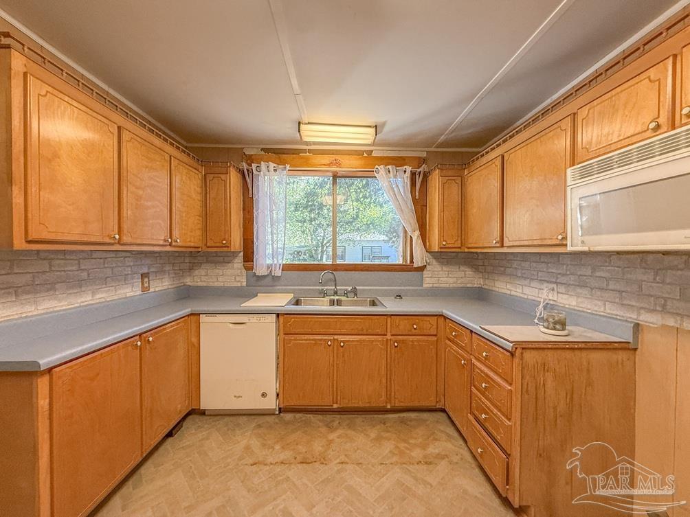 4550 Church Street Bagdad, FL 32583 - Photo 9 of 23 a kitchen with a sink window and cabinets