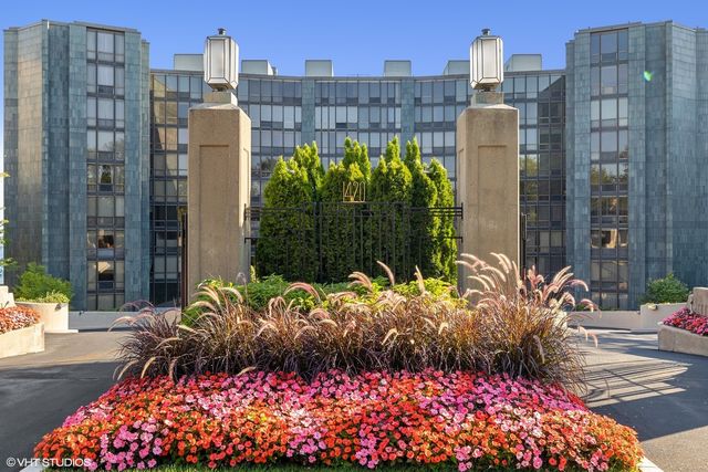 a view of a street with a flower garden