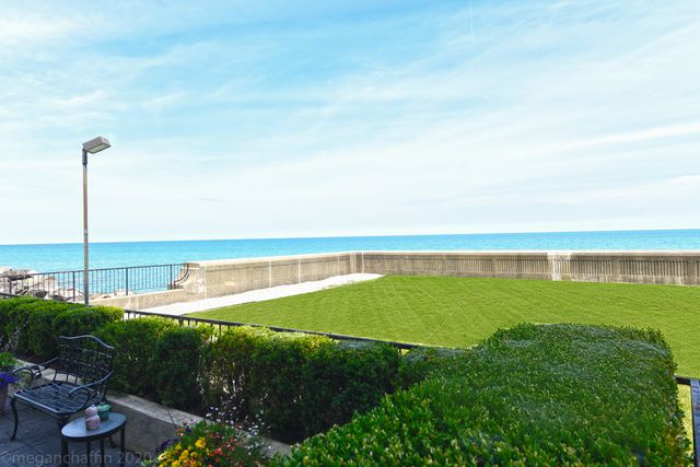 a kitchen with stainless steel appliances granite countertop a sink a stove and cabinets