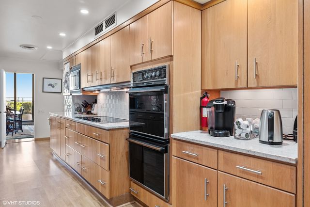 a view of a kitchen with cabinets and wooden floor