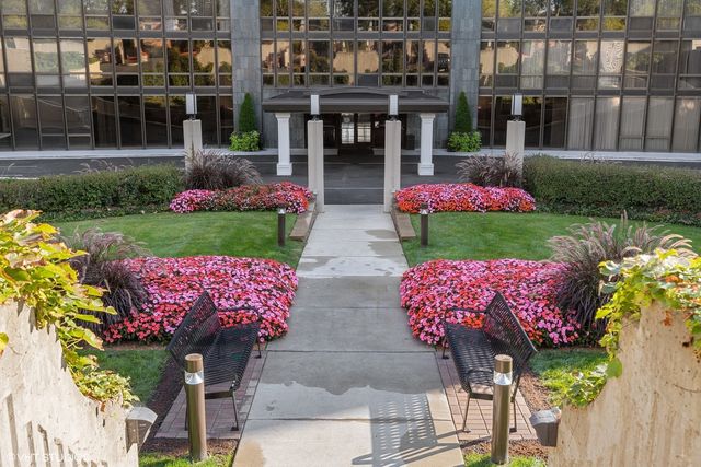 a view of a chairs and table in backyard of the house