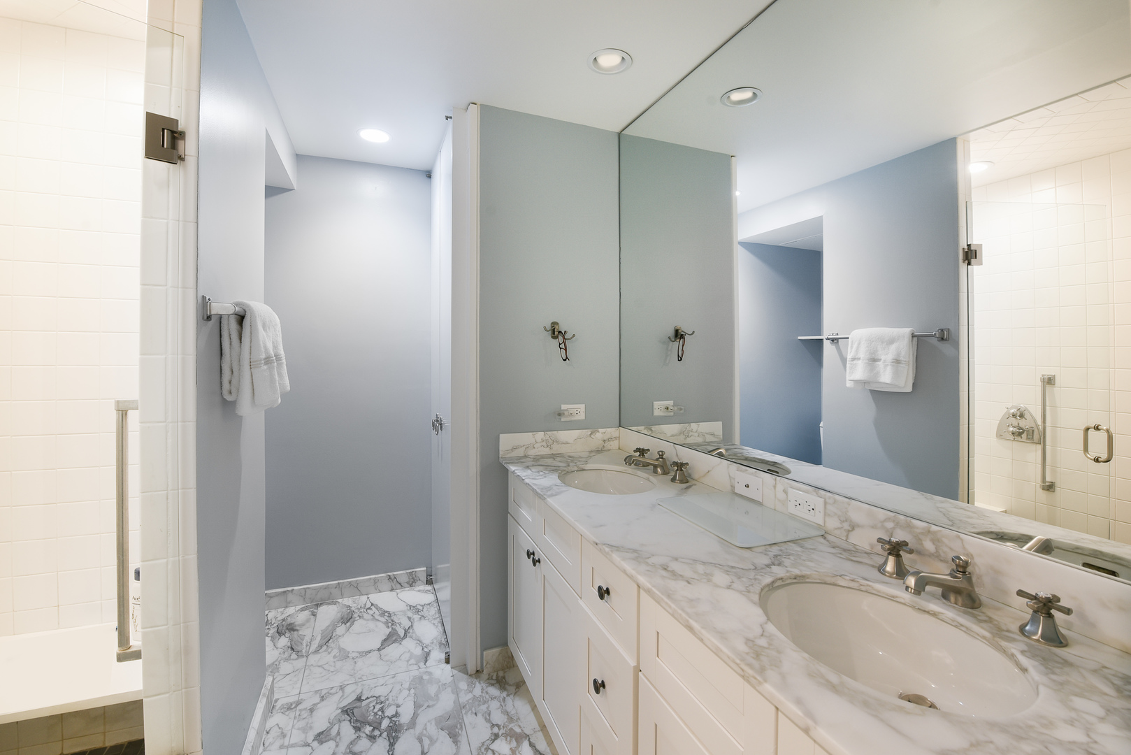 1420 Sheridan Road, Unit 1E Wilmette, IL 60091 - Photo 30 of 47 a bathroom with a granite countertop double vanity sink and mirror