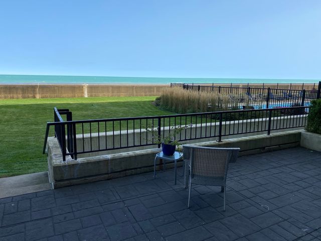 a view of a bench in the roof deck with a yard