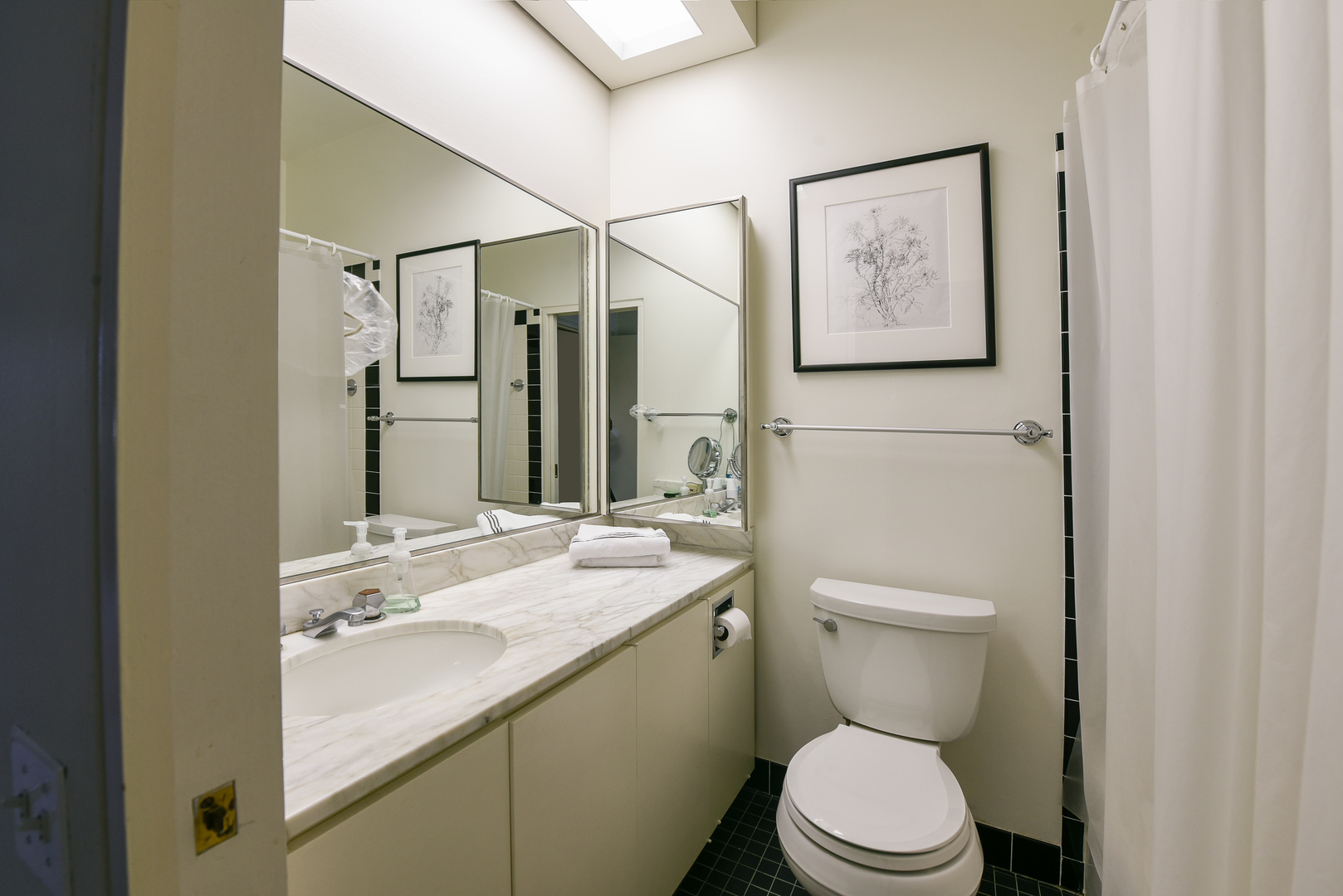 1420 Sheridan Road, Unit 1E Wilmette, IL 60091 - Photo 33 of 47 a bathroom with a toilet sink and mirror