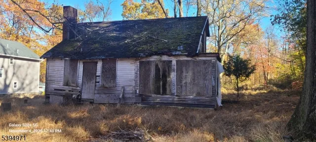 a view of a house with a small yard and wooden fence