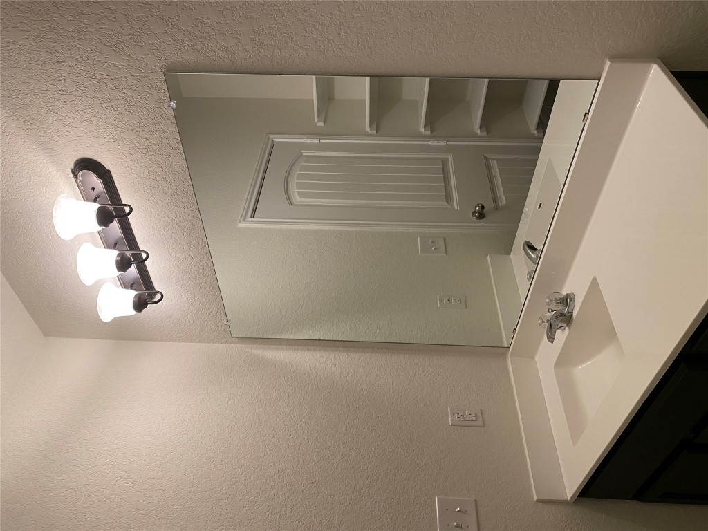 3607 Conyers Lane Austin, TX 78725 - Photo 16 of 24 a bathroom with a sink and a mirror