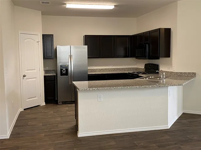 a kitchen with a refrigerator and a sink
