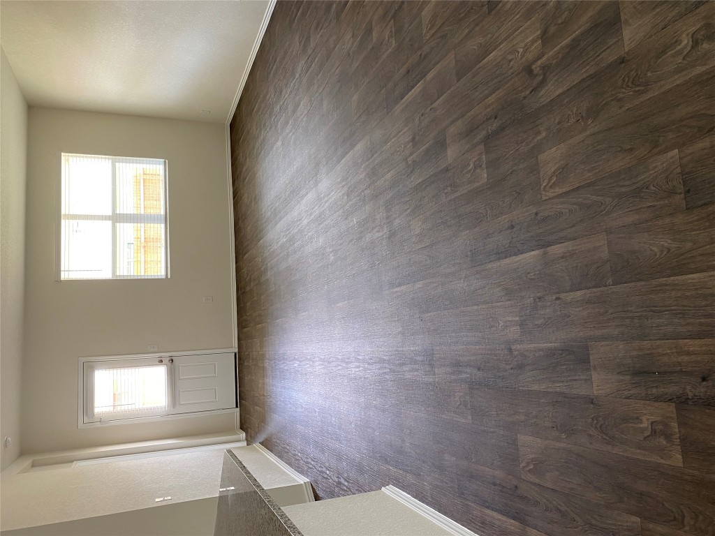 3607 Conyers Lane Austin, TX 78725 - Photo 7 of 24 an empty room with wooden floor and windows