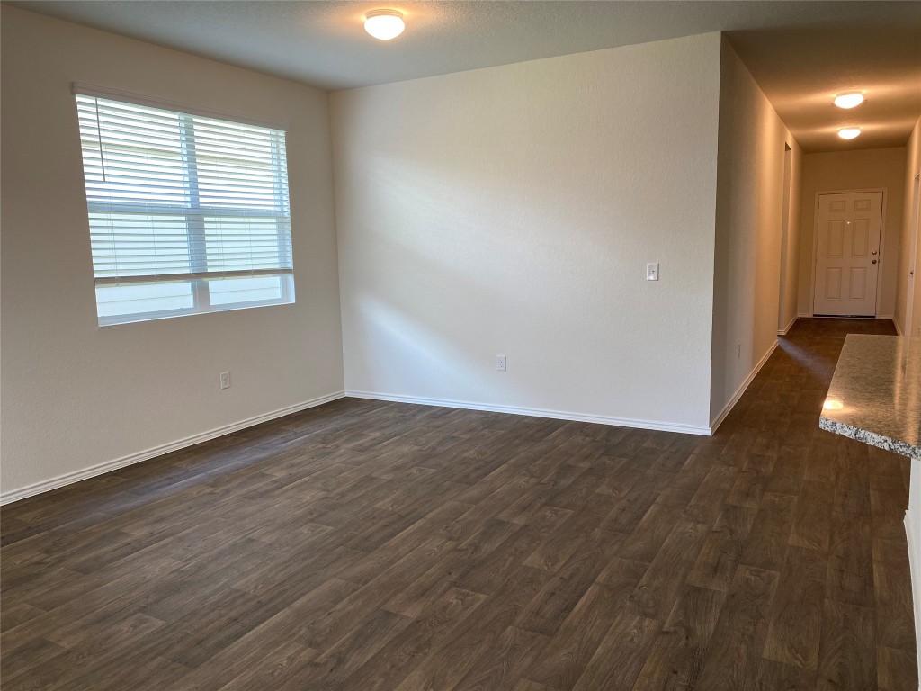 3607 Conyers Lane Austin, TX 78725 - Photo 8 of 24 an empty room with wooden floor and windows