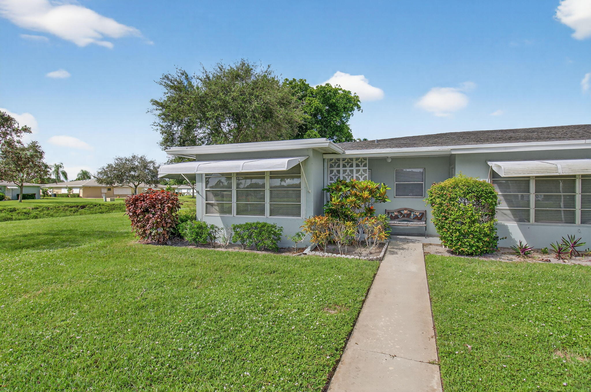 300 High Point Boulevard, Unit A Delray Beach, FL 33445 - Photo 2 of 37 a front view of a house with garden