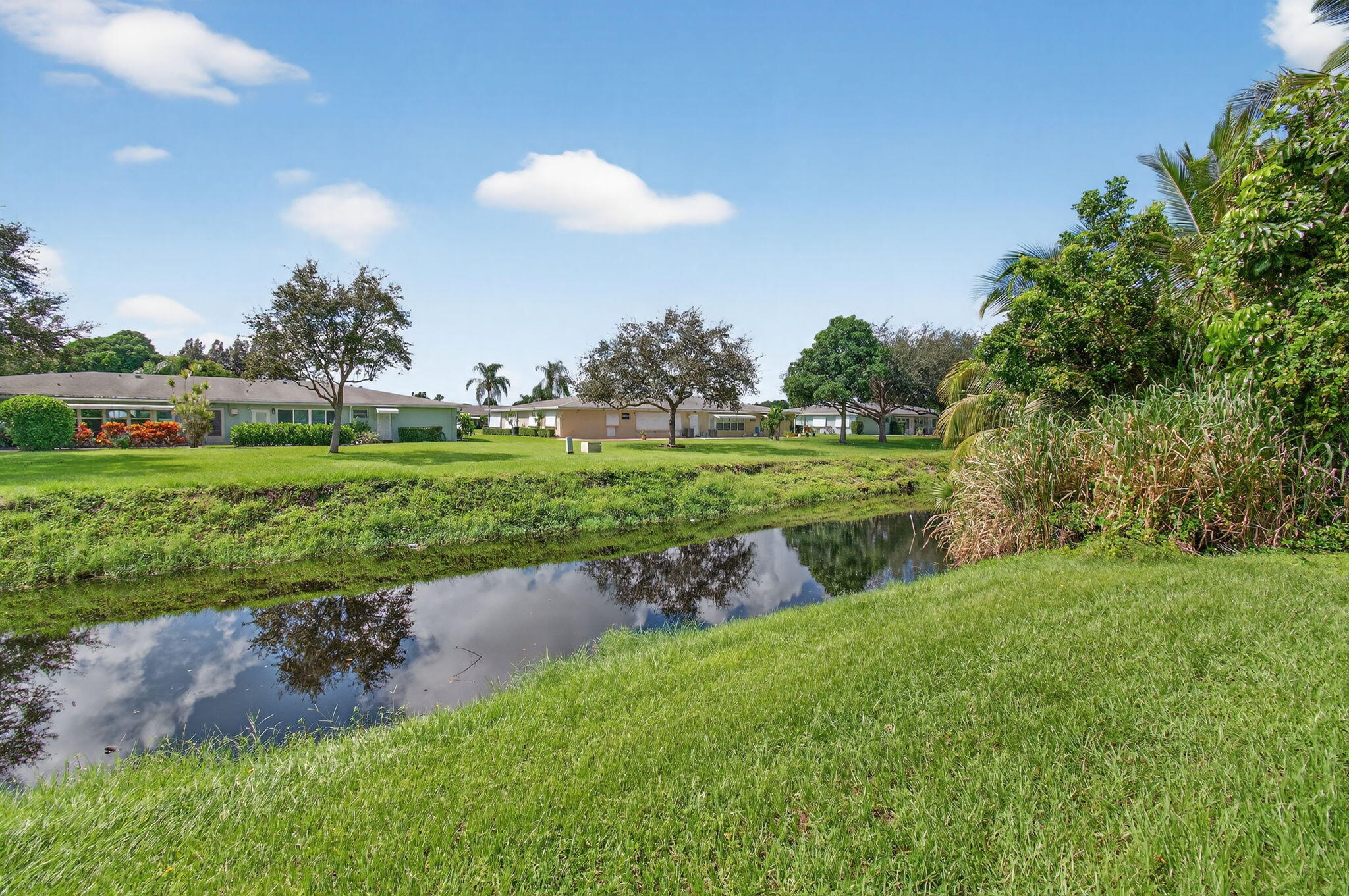 300 High Point Boulevard, Unit A Delray Beach, FL 33445 - Photo 36 of 37 a view of a golf course with a lake