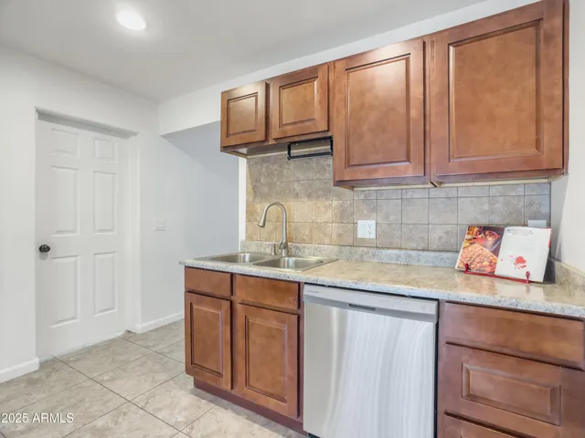 a kitchen with stainless steel appliances granite countertop a sink and cabinets
