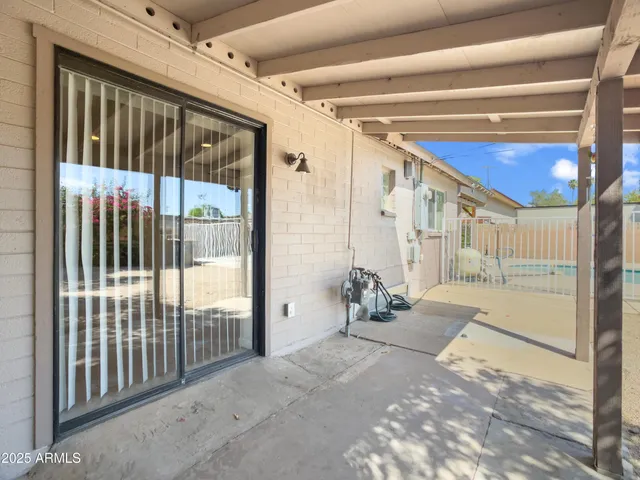a view of a porch with wooden floor and a fireplace