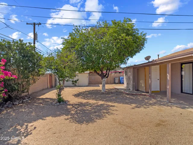 a view of a swimming pool with a patio and a garden