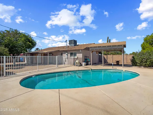 a view of a house with swimming pool and sitting area