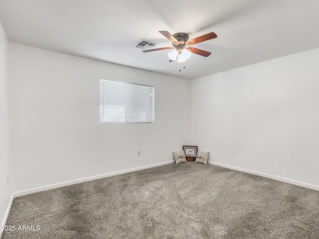 a view of room with window and ceiling fan