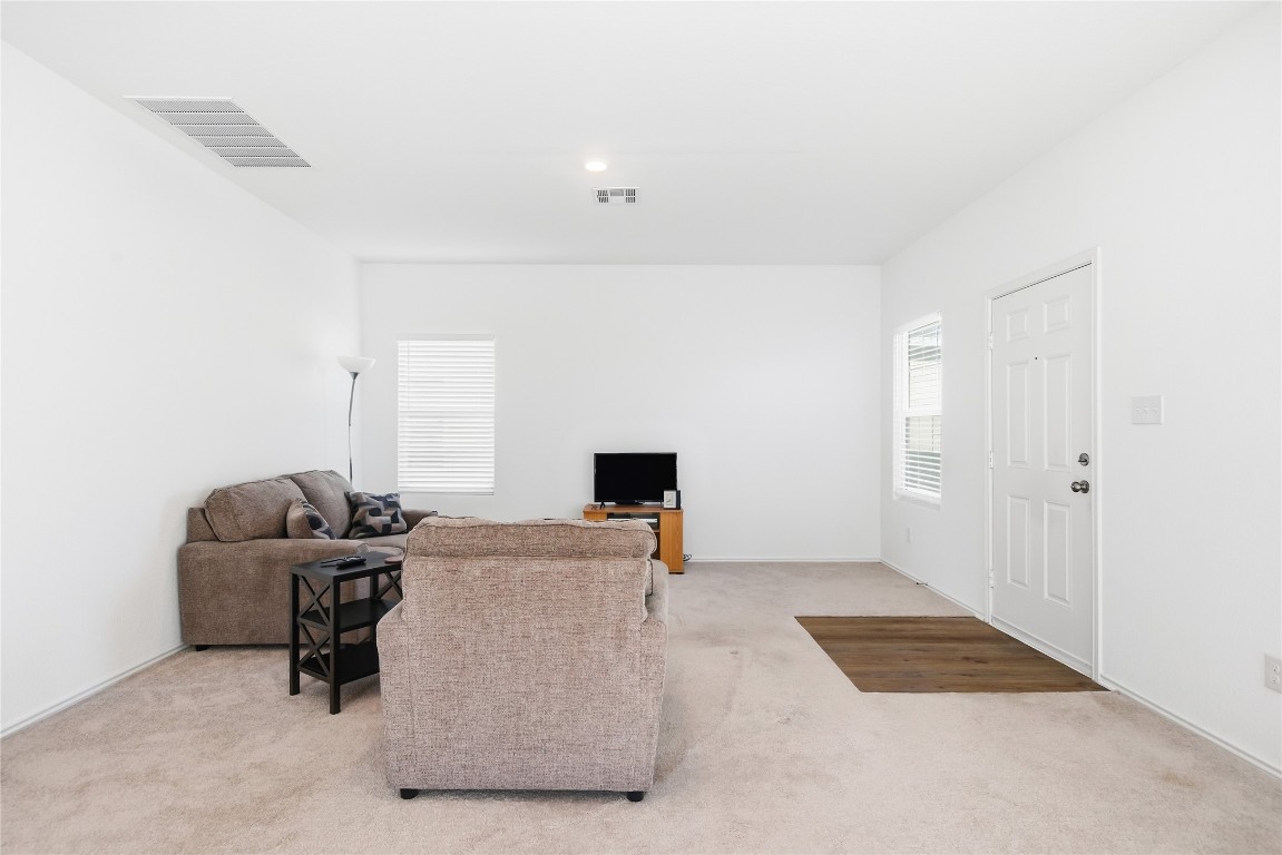 724 Rancho Del Cielo Loop Jarrell, TX 76537 - Photo 11 of 34 a living room with furniture and a flat screen tv