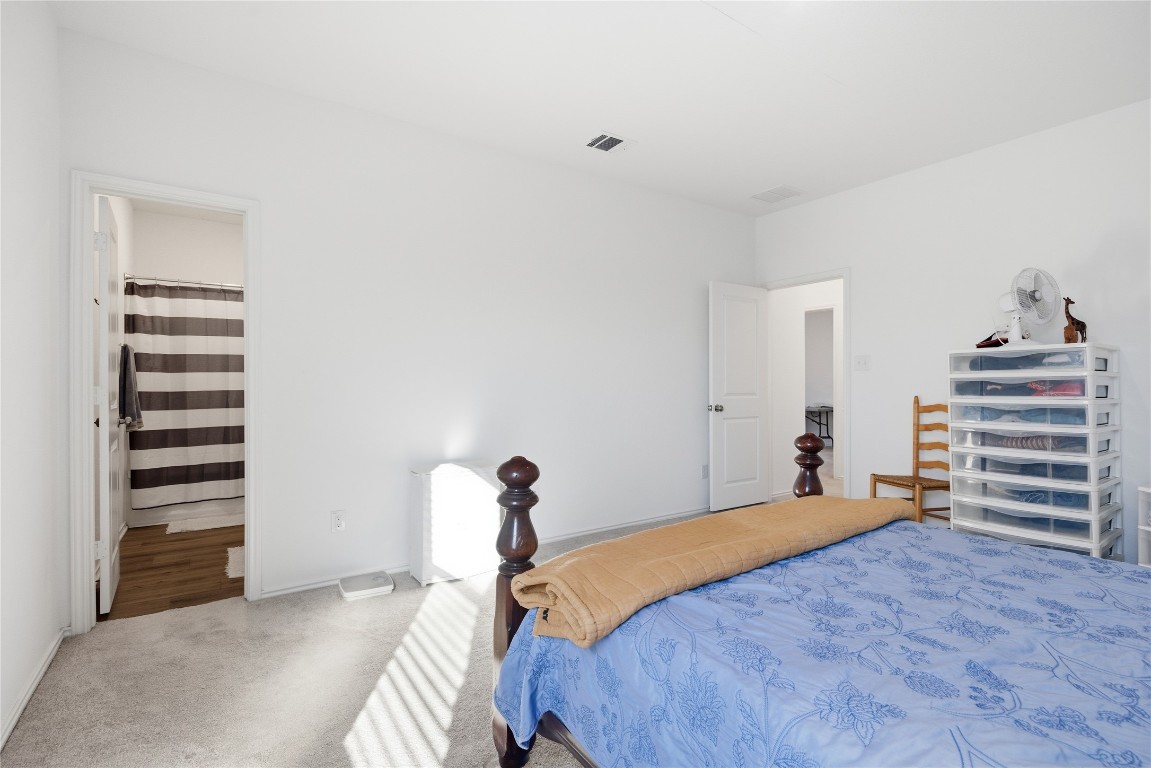 724 Rancho Del Cielo Loop Jarrell, TX 76537 - Photo 16 of 34 a bedroom with a bed and cabinets