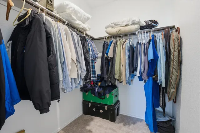 a bedroom with a bed and cabinets