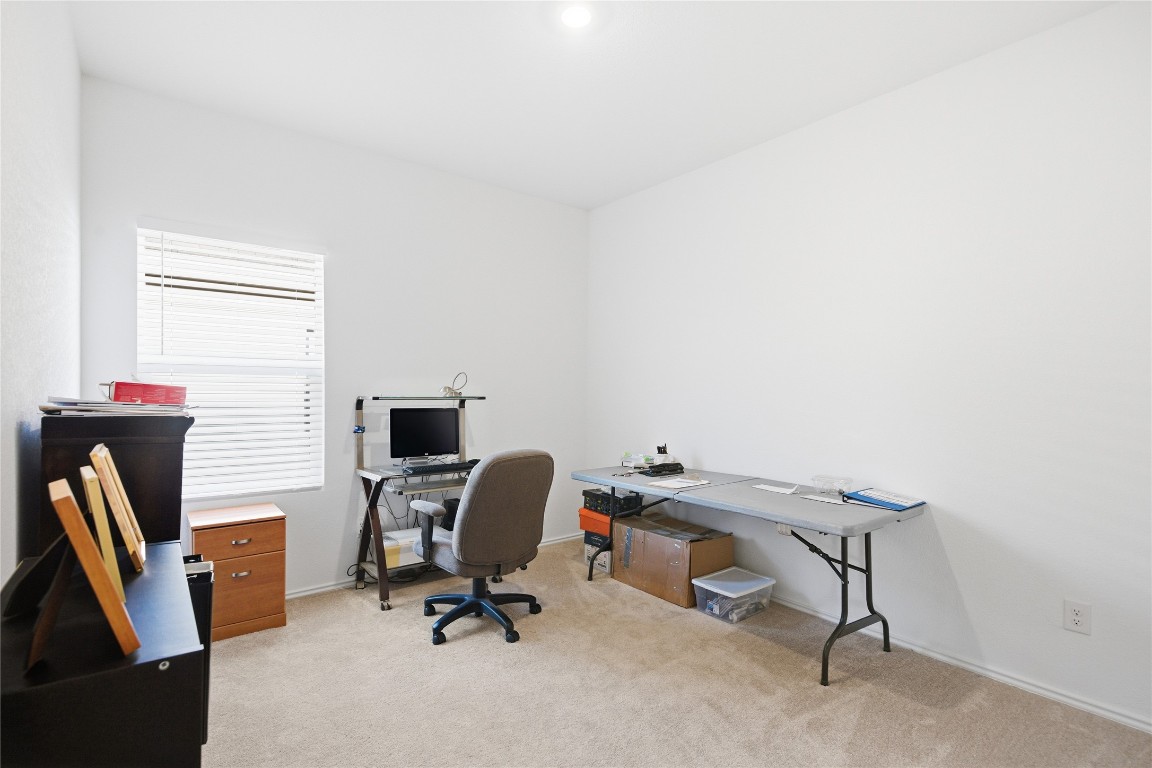 724 Rancho Del Cielo Loop Jarrell, TX 76537 - Photo 19 of 34 a view of a workspace with furniture and a window