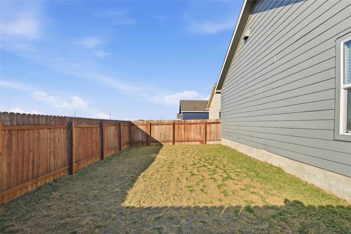 724 Rancho Del Cielo Loop Jarrell, TX 76537 - Photo 22 of 34 a view of backyard with wooden fence