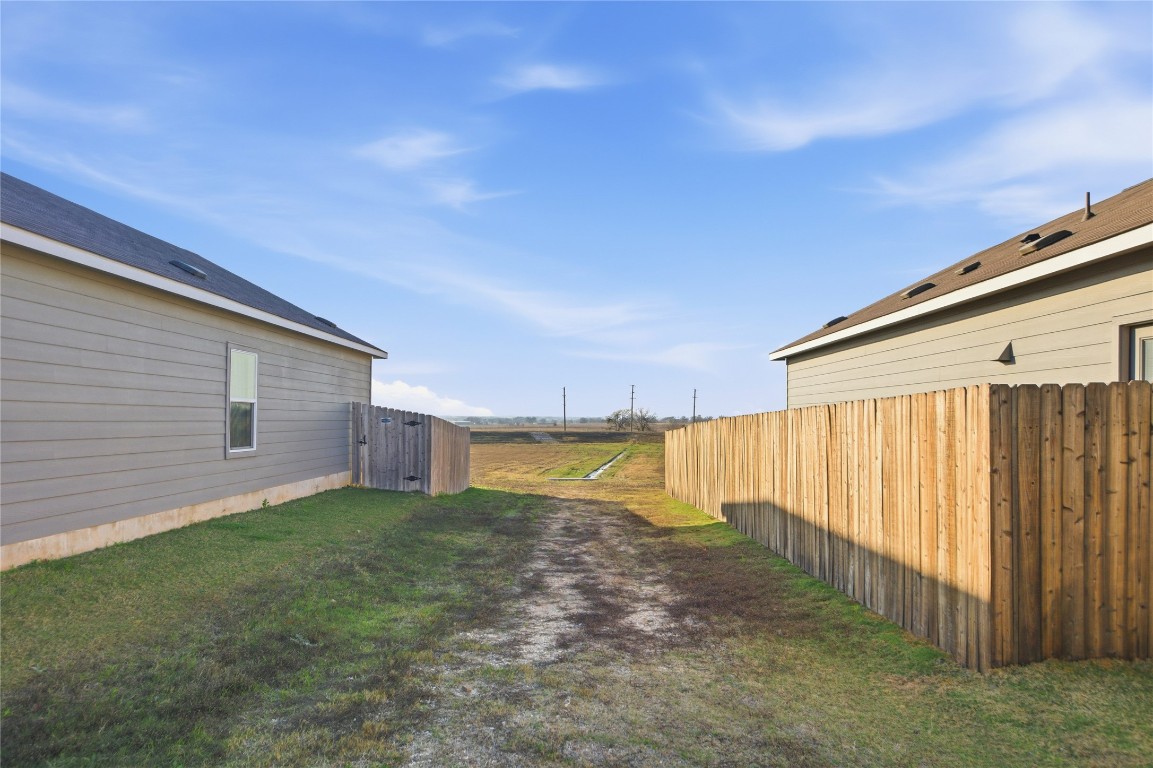 724 Rancho Del Cielo Loop Jarrell, TX 76537 - Photo 29 of 34 a view of a backyard with plants