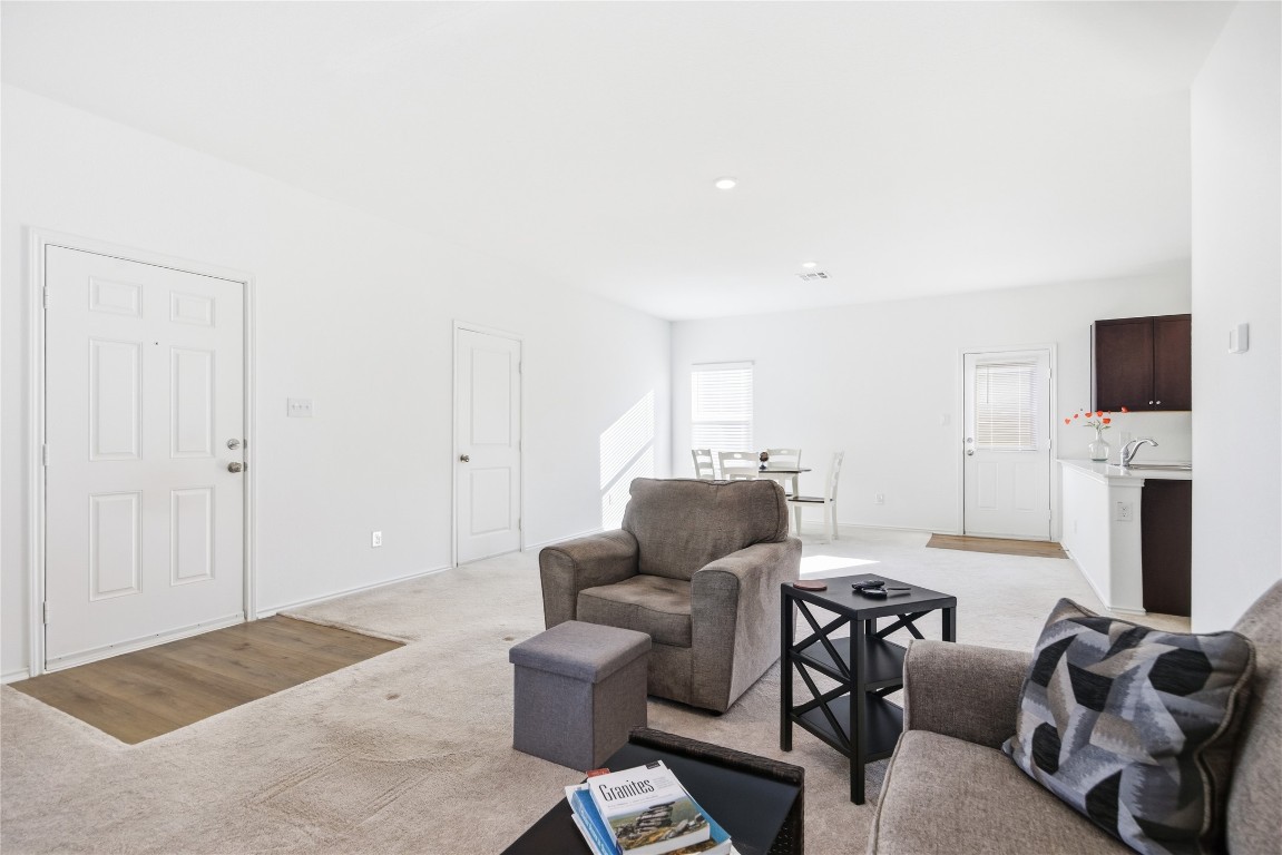 724 Rancho Del Cielo Loop Jarrell, TX 76537 - Photo 8 of 34 a living room with furniture a flat screen tv and a fireplace