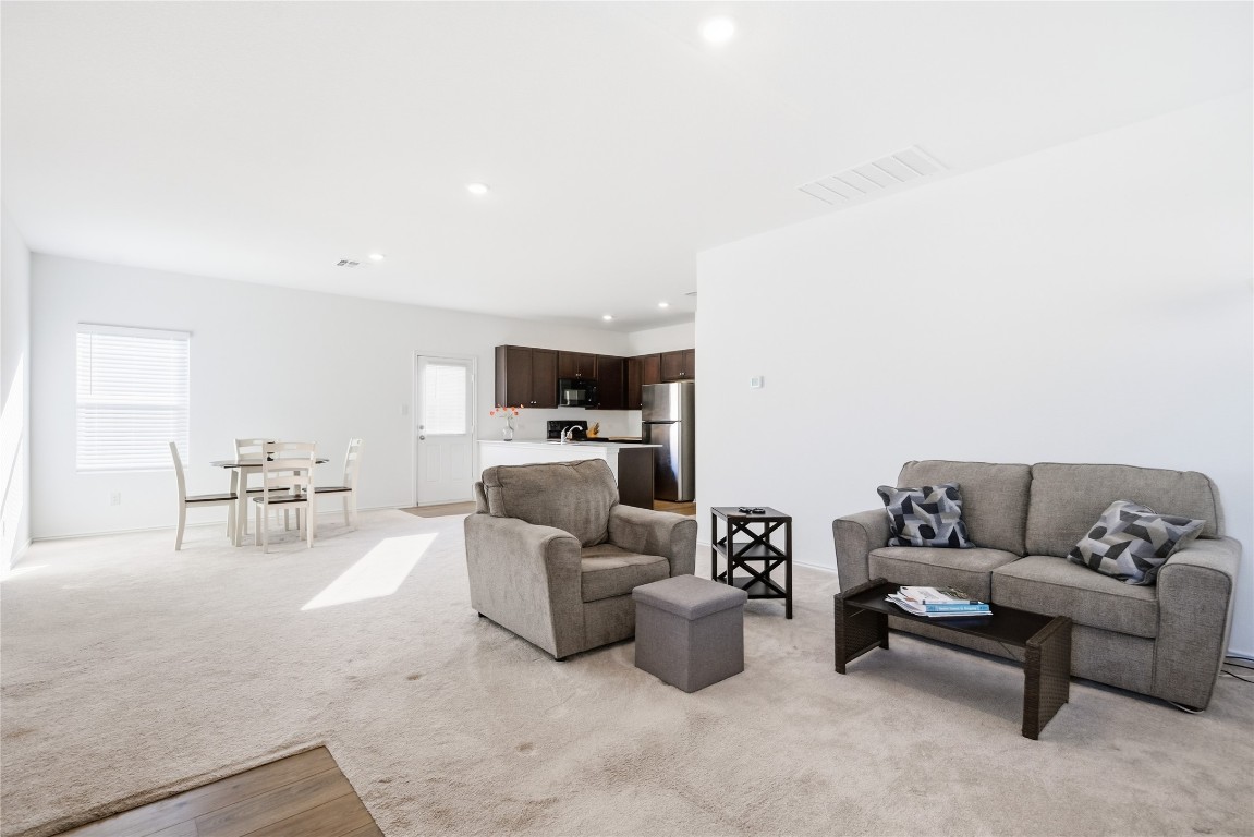 724 Rancho Del Cielo Loop Jarrell, TX 76537 - Photo 9 of 34 a living room with furniture and a couch
