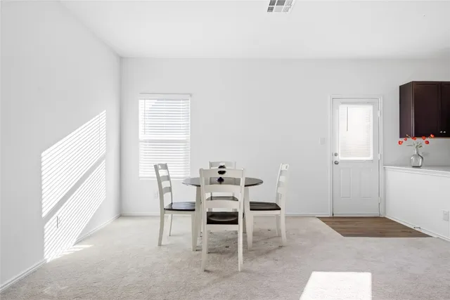a dining room with furniture and window