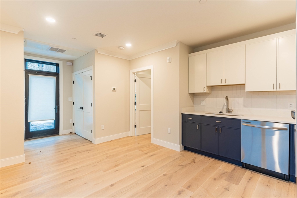 157 Everett Street, Unit 102 Boston, MA 02134 - Photo 3 of 7 a view of kitchen with granite countertop cabinets and sink