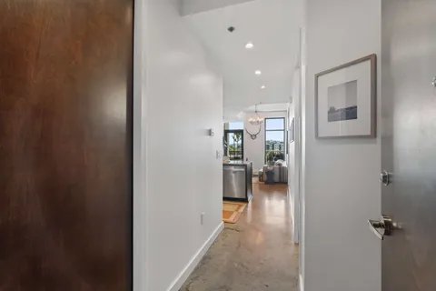 a view of a hallway with furniture and a livingroom