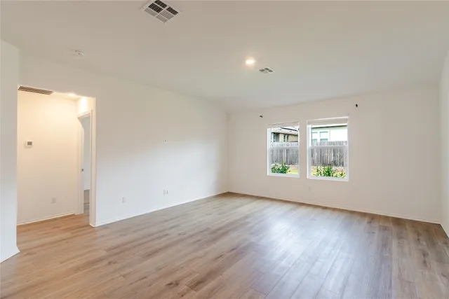 an aerial view of residential houses with outdoor space and ocean view