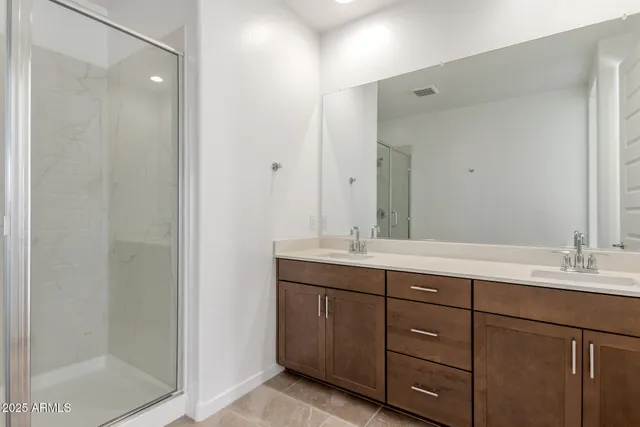 a bathroom with a double vanity sink and mirror
