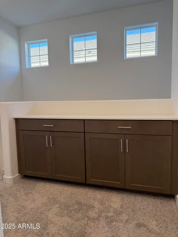 a room with a cabinets and a window
