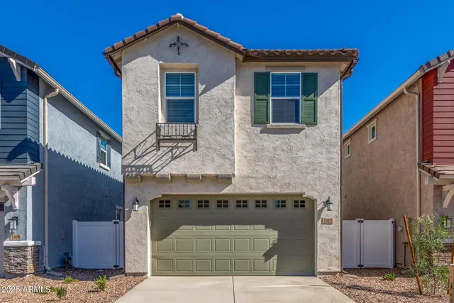 a front view of a house with large windows