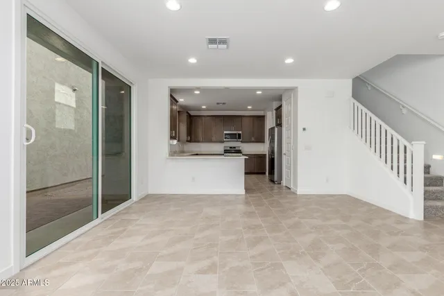 a view of a kitchen with a sink and a refrigerator