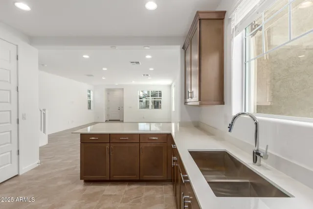 a kitchen with a sink stove and cabinets