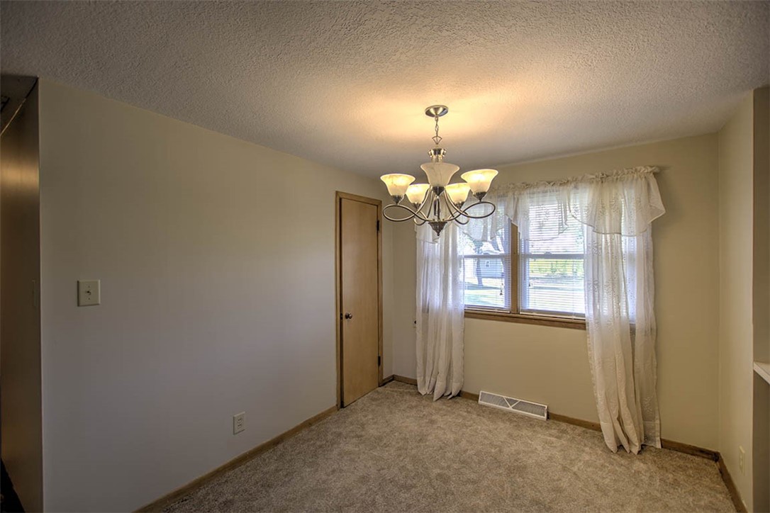 2913 South Danny Drive Decatur, IL 62521 - Photo 17 of 31 an empty room with chandelier fan and windows