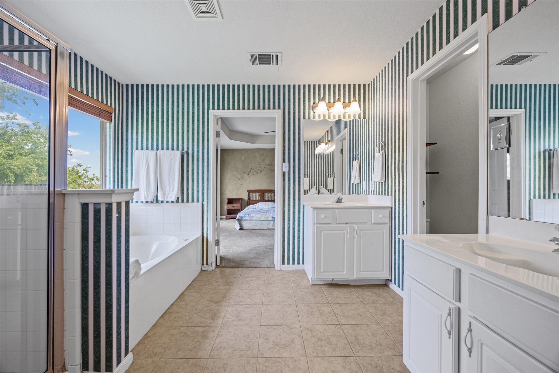 402 Autumn Trail Georgetown, TX 78626 - Photo 20 of 25 a en suite bathroom with a sink and mirror