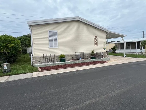 a front view of a house with a yard and outdoor seating