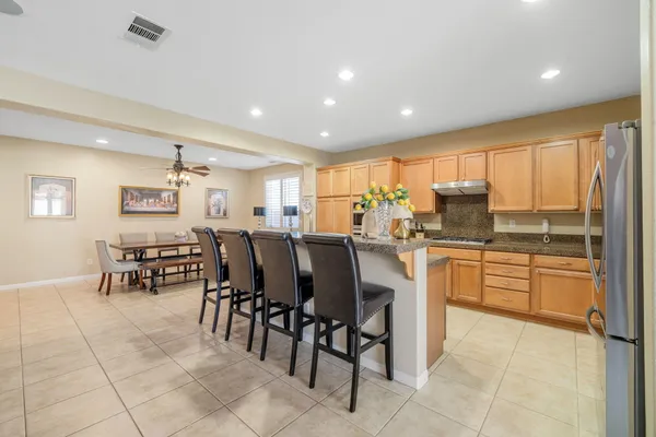 a kitchen with stainless steel appliances granite countertop a refrigerator and cabinets