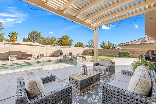 a view of swimming pool with outdoor seating and city view