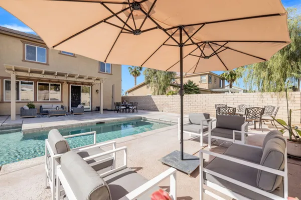 a view of a patio with a table and chairs